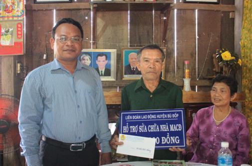 (Ông Điểu Nen - Chủ tịch LĐLĐ huyện Bù Đốp trao tiền hỗ trợ sửa chữa nhà 'Mái ấm Công đoàn' cho gia đình ông Nguyễn Tuấn Hàn).